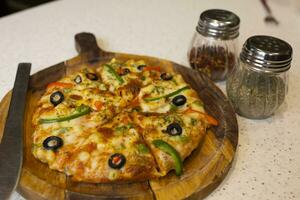 Vegetarian Delicious Capsicum Pizza Made From Capsicum, Cheese, Tomatoes, Peppers, Onions And Olives photo