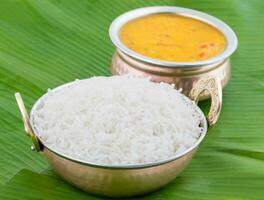 Indian Traditional Cuisine Dal Fry or Rice Also Know as Dal Chawal, Daal Chawal, Dal Rice, Whole Yellow Lentil with Rice or Dal Tadka, Daal Fry Served with Rice isolated on White Background photo