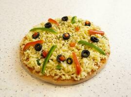 Vegetarian Delicious Capsicum Pizza Made From Capsicum, Cheese, Tomatoes, Peppers, Onions And Olives photo