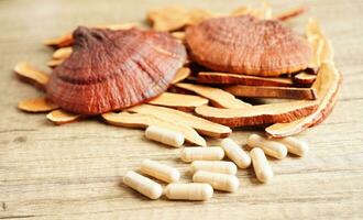 Lingzhi or Reishi mushroom with capsules, organic natural healthy food. photo