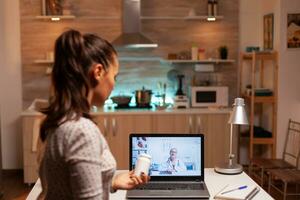 Sick woman holding bottle of pills during video conference asking for advice. Physician giving consultation to sick patient from hospital office during virtual conference, device, medicine, appointment. photo