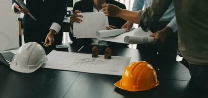 Construction and structure concept of Engineer or architect meeting for project working with partner and engineering tools on model building and blueprint in working site, contract for both companies. photo