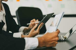 Close up of Business team analyzing income charts and graphs with modern laptop computer. Business analysis and strategy concept. photo