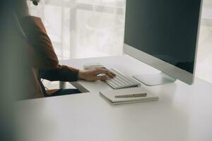 Beautiful female call center operator working on computer in office photo