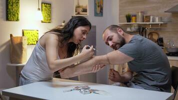 Drug addicted couple in the kitchen. Persons using to heroin, cocaine, amphetamine abuse with side effects suffers from pain making seizures, social disaster and narcotics addiction epidemic. photo