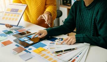 UX developer and ui designer brainstorming about mobile app interface wireframe design with customer breif and color code photo
