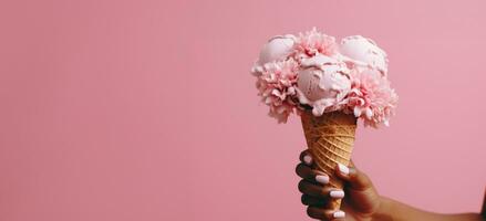 AI generated a hand holds a pink ice cream cone in front of a pink flower photo