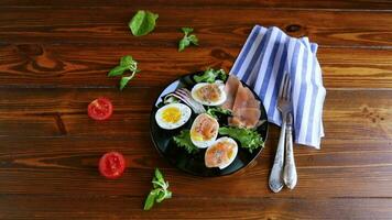 boiled eggs with salted red fish, herbs and seasonings in a plate on a wooden table. video