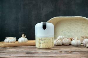 Garlic in a fine blender on a black background photo