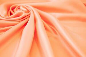 Stylish bright orange fabric stripes, blurred background photo