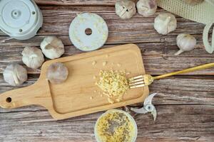 Garlic from a fine blender on a wooden plate photo