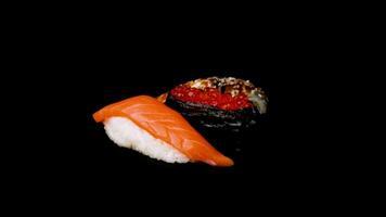 Sushi set black background. Side view. Rotate 360 slow motion video 4K