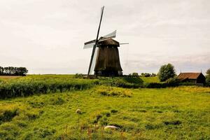 a windmill in the middle of a field photo