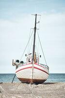 pescar barco acostado en el playa en del Norte Dinamarca foto