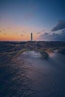 white sands and Lighthouse in the dunes of the danish north sea coast photo