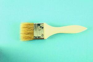 a brush with a white handle on a blue background photo