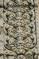 detail of the carved stone at angkor wat, cambodia photo