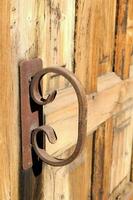 a close up of a door handle on a wooden door photo