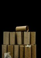 a pile of toilet paper rolls on a black background photo