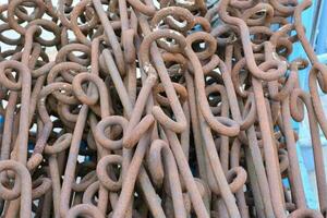 a pile of rusty metal hooks in a warehouse photo