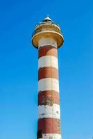 a red and white striped lighthouse photo