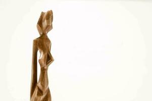 a wooden sculpture of a woman photo