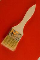 a paint brush on a red background photo