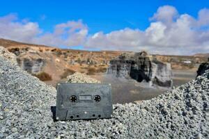 a cassette sitting on top of rocks photo