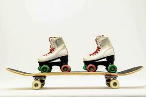 two pairs of roller skates on top of a skateboard photo