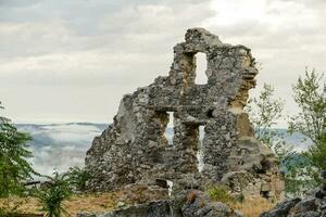 the ruins of an old castle in the mountains photo