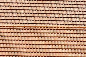 a close up of a red roof with many different tiles photo