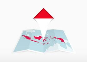 Indonesia is depicted on a folded paper map and pinned location marker with flag of Indonesia. vector