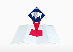 Wyoming is depicted on a folded paper map and pinned location marker with flag of Wyoming. vector