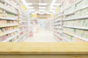 Empty wood table top with supermarket blurred background for product display photo