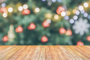 Empty wood table top with blur Christmas tree with bokeh light background photo