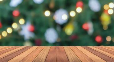 Empty wood table top with blur Christmas tree with bokeh light background photo