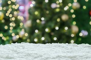 Empty white snow with blur Christmas tree with bokeh light background photo