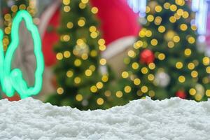 Empty white snow with blur Christmas tree with bokeh light background photo