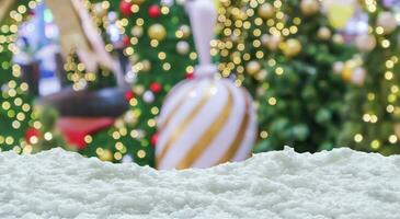 Empty white snow with blur Christmas tree with bokeh light background photo