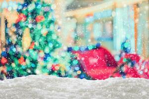 Empty white snow with blur Christmas tree with bokeh light background photo