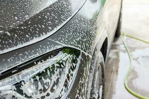 car cleaning and washing with foam soap photo