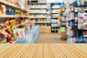 Empty wood table top with supermarket blurred background for product display photo