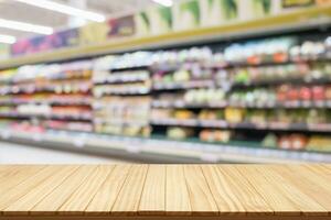 Empty wood table top with supermarket blurred background for product display photo