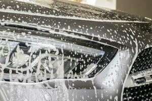 car cleaning and washing with foam soap photo