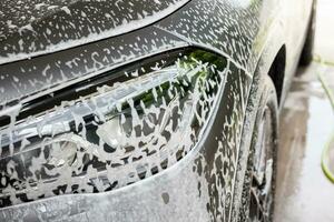 car cleaning and washing with foam soap photo