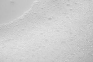 Abstract white soap foam bubbles texture on white background photo