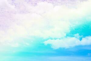 Beautiful rainbow pastel color with clouds and blue sky photo