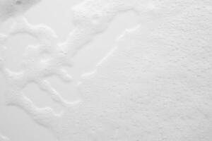 Abstract white soap foam bubbles texture on white background photo