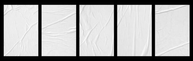 white crumpled and creased glued paper poster set isolated on black background photo