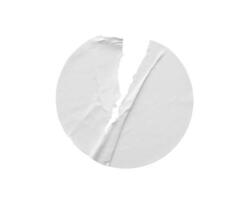 Blank white round torn paper sticker label isolated on white background photo